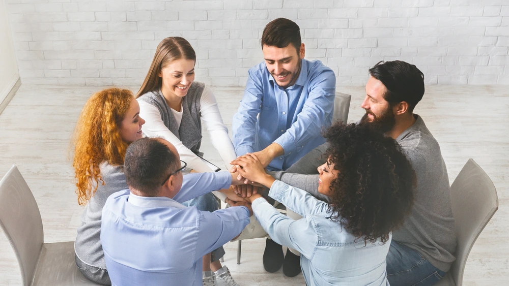 Engaged Employees Stacking Their Hands Together