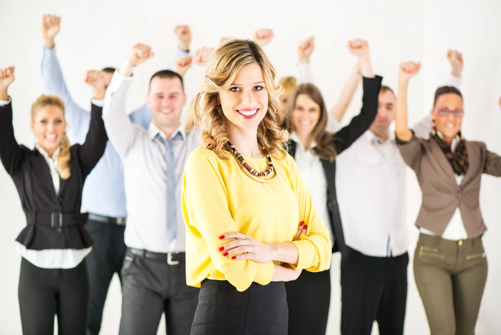 A Leader Standing In Front Of A Team Of Engaged Staff