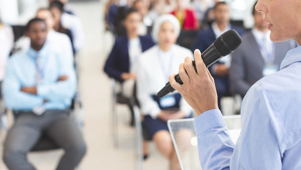 A Woman Speaks To Diverse Business People