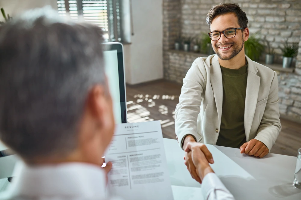 A Successful Candidate Shaking Hands With Employer