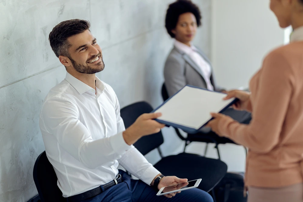 An Hr Offering Questionnaires For Job Interview Evaluations To Candidates