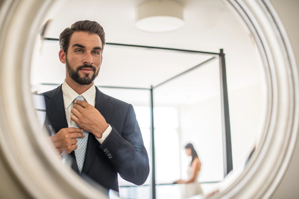 Reflection in Mirror of Young Businessman Adjusting S 2026 03 10 02 05 51 Utc 1