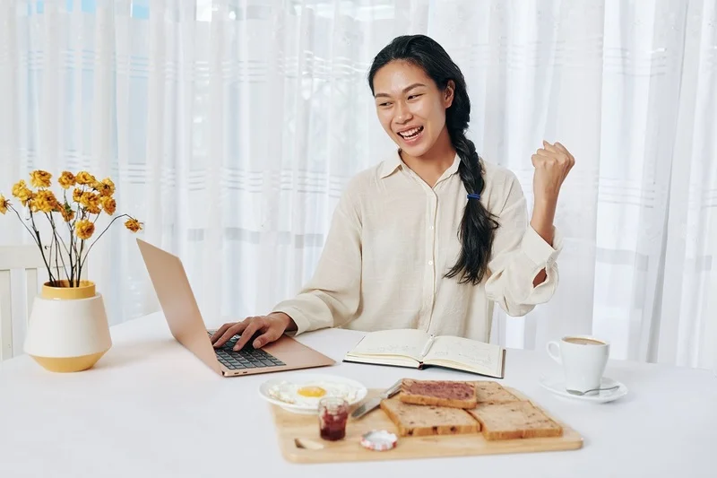 A Woman Is Happy Reading A Guide On How To Respond To An Interview Request While Having A Breakfast