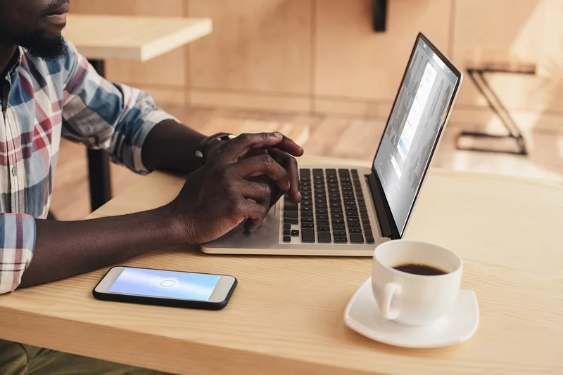 A Man Signing In To His Linkedin Account On A Laptop, Clear Visual To Show How To Add Resume To Linkedin.