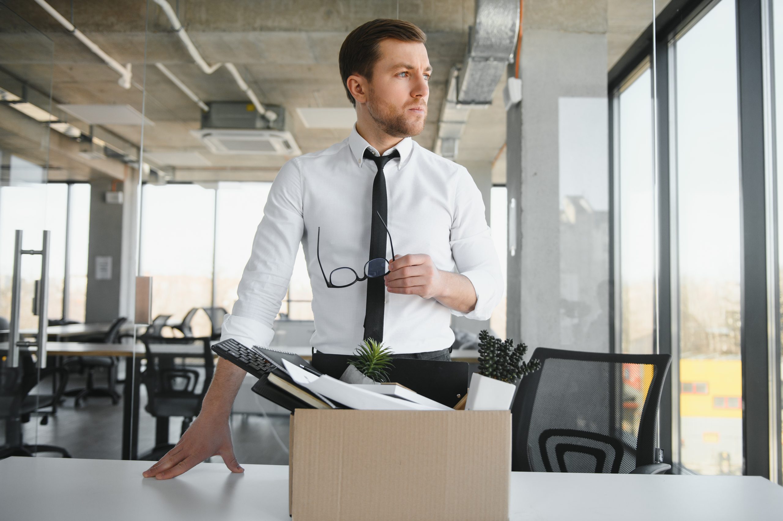 Young Man Packing His Belongings After Job Loss, Showing The Result Of Progressive Discipline
