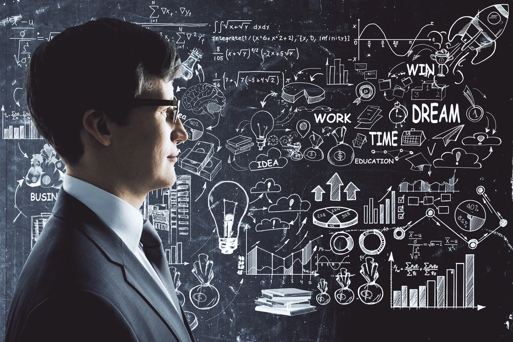 A Side Portrait Of A Professional With A Business Strategy Chalkboard Representing The Concept Of Empathetic Listening